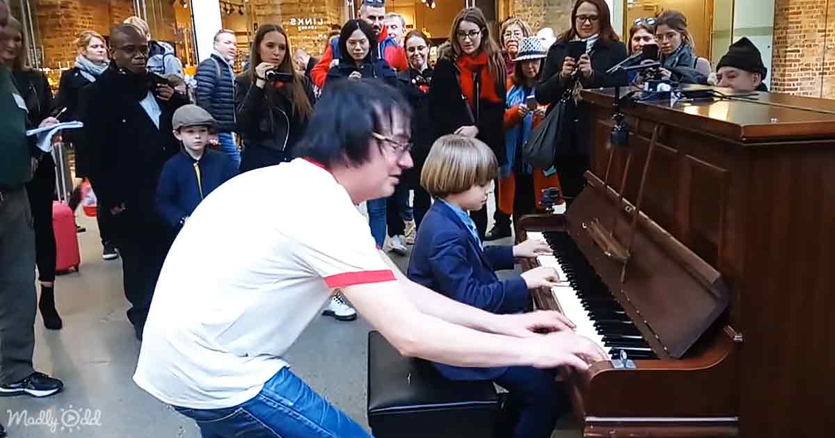 Terry Miles and an little boy playing a public piano
