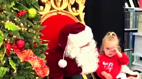 All this little girl wants for Christmas is to take a nap on Santa’s lap